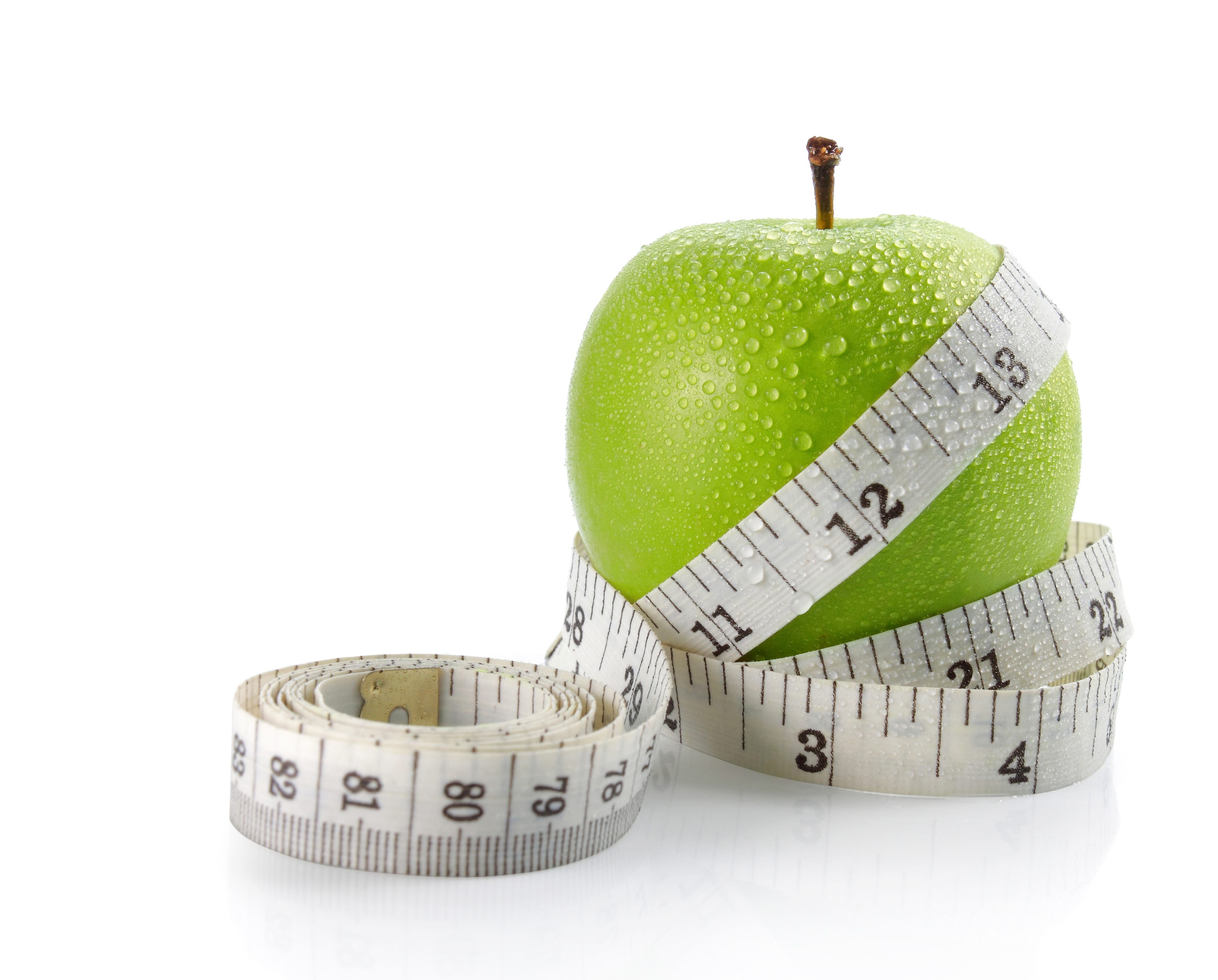 fresh apple with measuring tape. isolated over white background